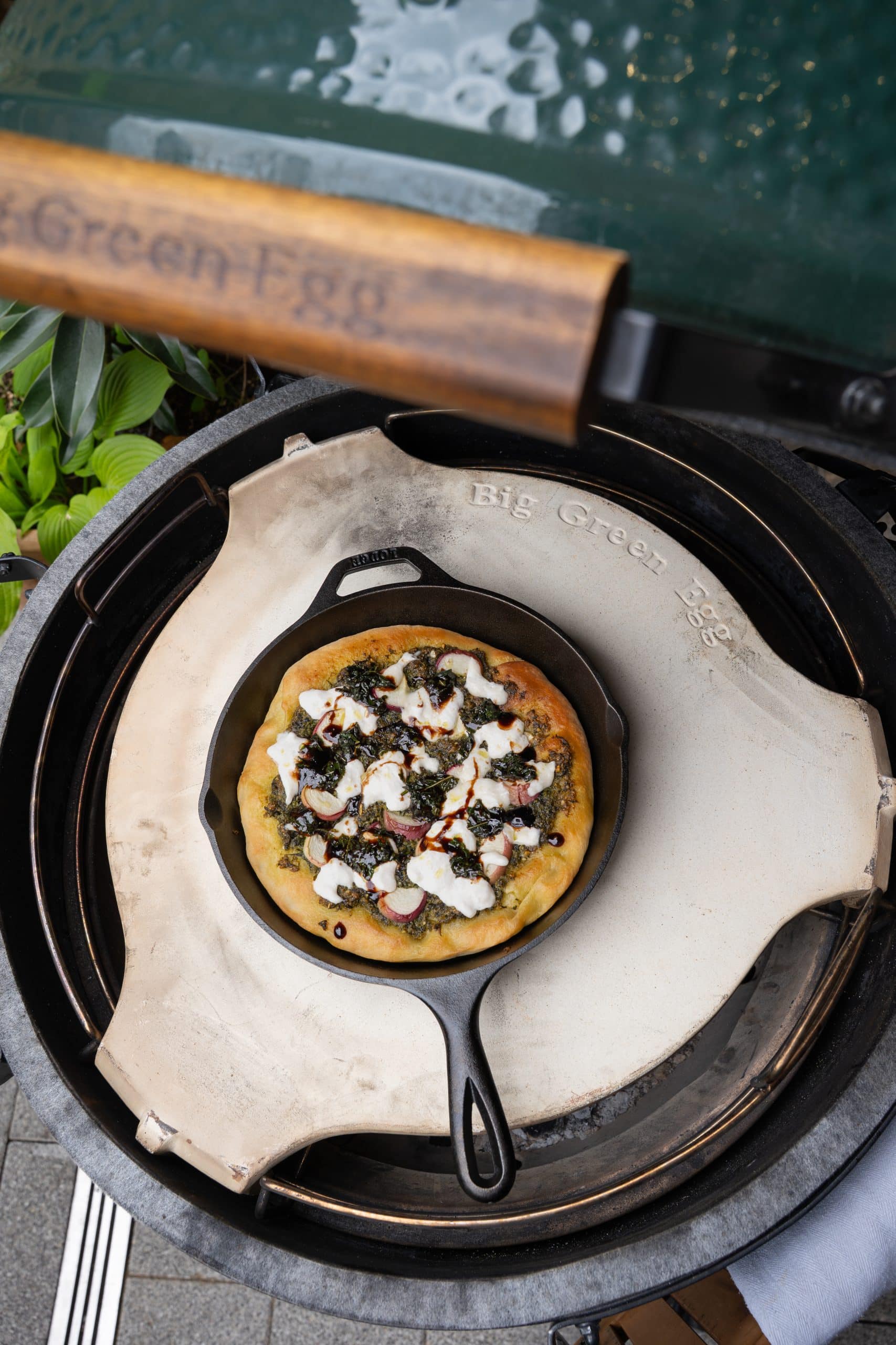 Pizza with pesto, burrata and peaches cooked in a skillet